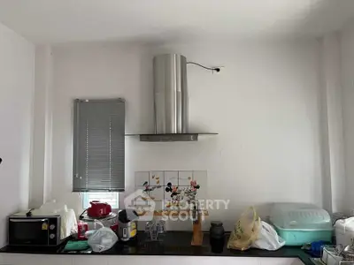 Modern kitchen with stainless steel range hood and appliances