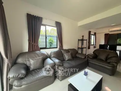 Spacious living room with leather sofas and modern decor