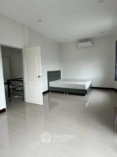 Spacious bedroom with modern minimalist design and air conditioning