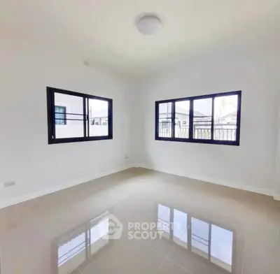 Spacious empty room with large windows and glossy tiled floor, perfect for customization.