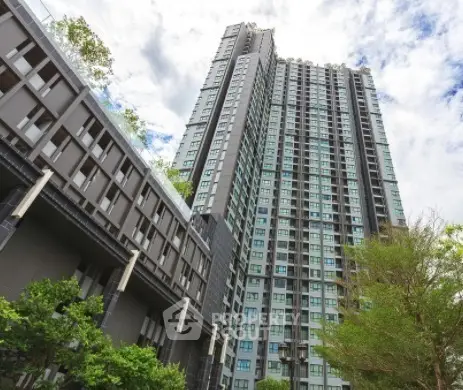 Stunning high-rise residential building with modern architecture and lush greenery.
