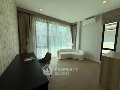 Spacious modern living room with elegant furniture and large windows for natural light.