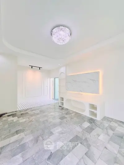 Spacious modern living room with elegant marble flooring and stylish lighting
