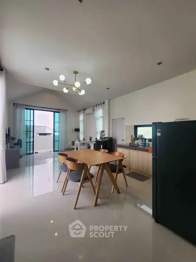 Spacious modern kitchen with open layout and elegant dining area in a bright, airy home.
