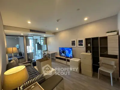 Modern living room with stylish furniture and TV, featuring a cozy ambiance and contemporary design.