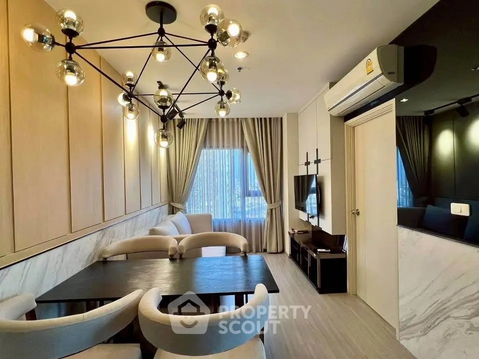 Modern living room with stylish lighting and elegant decor in a high-rise apartment.