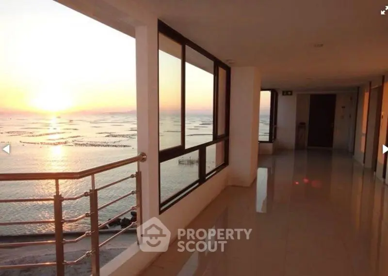 Stunning ocean view from modern building corridor at sunset