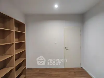 Minimalist study room with wooden shelves and sleek door