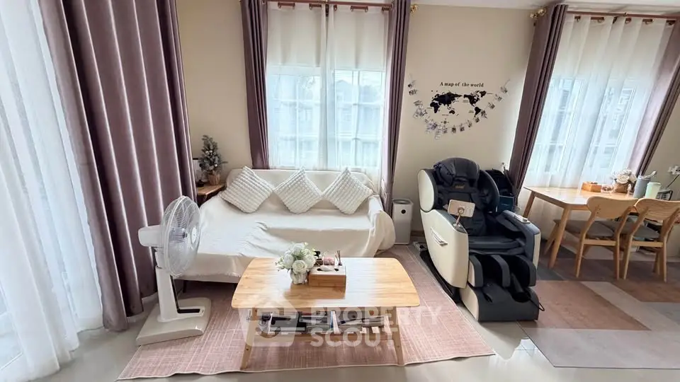 Charming living room with cozy sofa, massage chair, and elegant decor, perfect for relaxation and comfort.