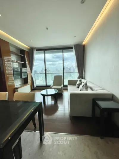 Modern living room with city view, featuring sleek furniture and large windows.