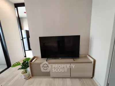 Modern living room with sleek TV setup and stylish wooden cabinet