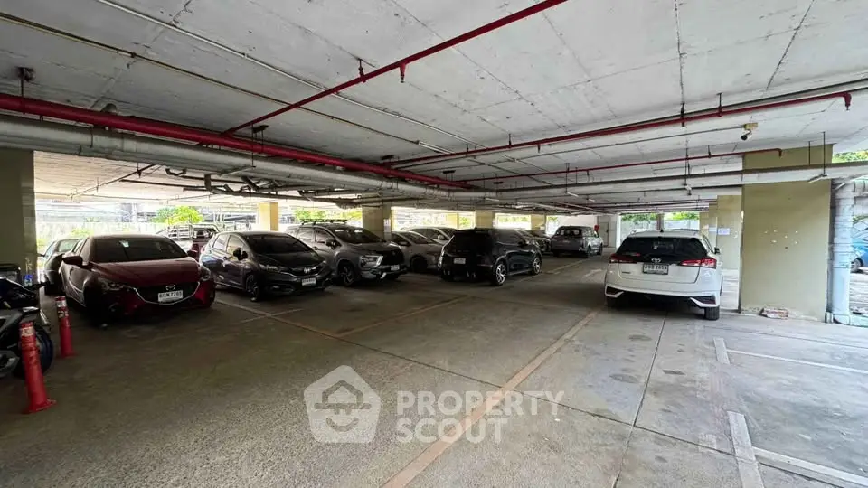 Spacious indoor parking area with multiple cars in a well-lit garage.