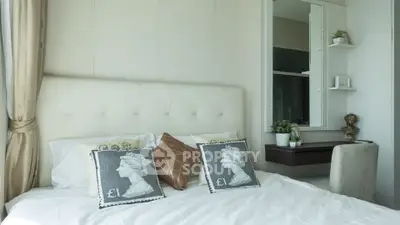 Luxurious bedroom with elegant decor and stylish cushions in modern apartment.