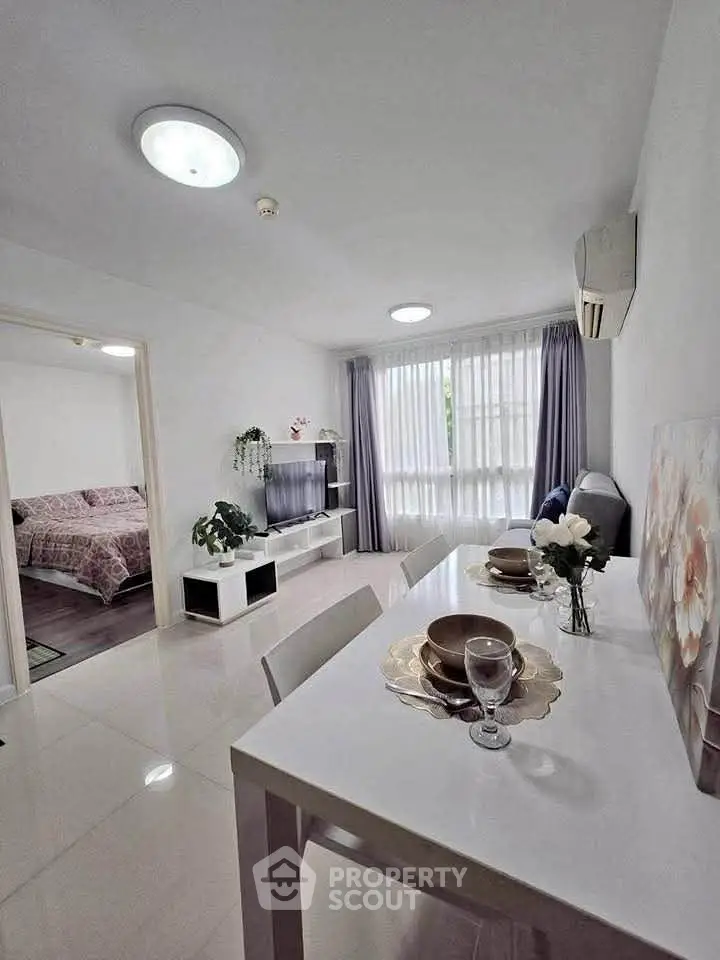 Modern open-plan living and dining area with elegant decor and natural light.