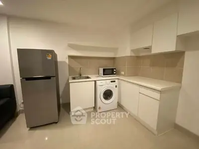 Modern kitchen with sleek appliances and ample storage space
