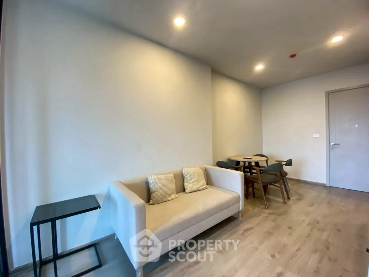 Modern living room with cozy sofa and dining area, perfect for relaxation and entertaining.