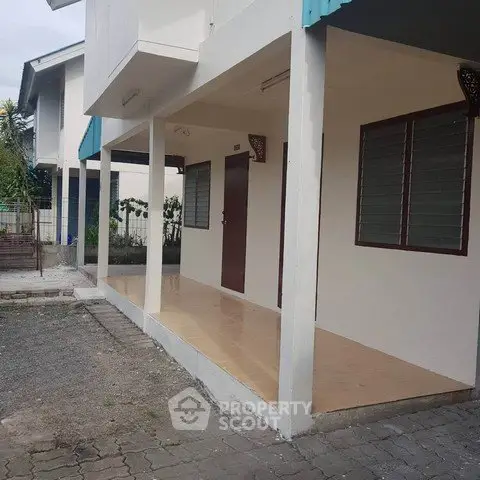 Charming single-story home with covered porch and ample outdoor space, perfect for family living.