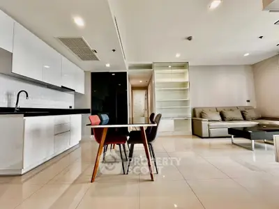 Modern open-plan living room with sleek kitchen and stylish dining area