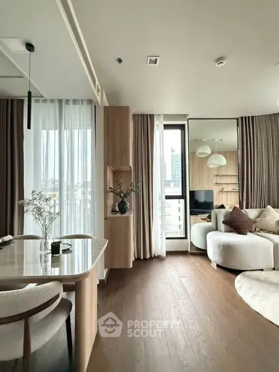 Modern living room with elegant decor and large windows offering city views