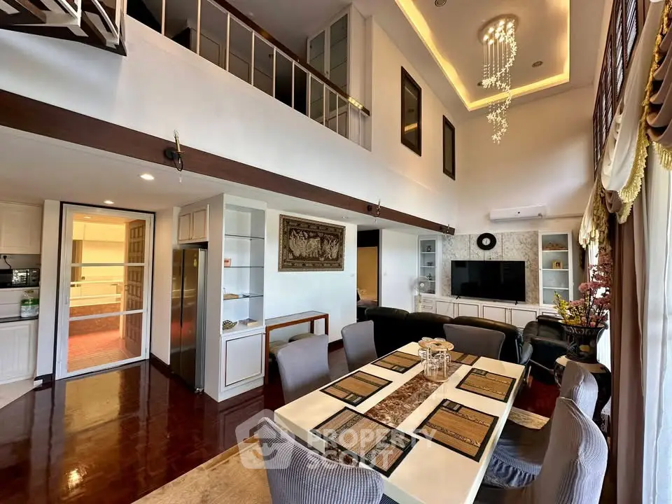 Luxurious open-plan living and dining area with high ceilings and elegant decor