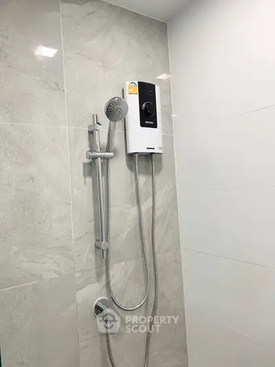 Modern bathroom with sleek shower and water heater installation.