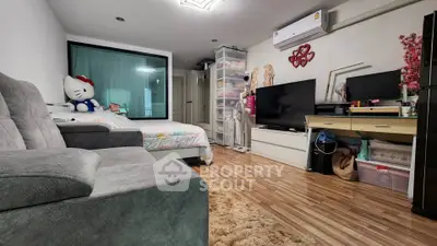 Cozy bedroom with modern decor and plush seating in stylish apartment