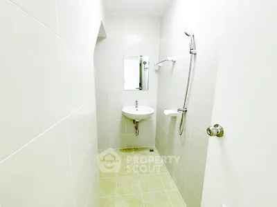 Minimalist bathroom with sleek white tiles and modern fixtures