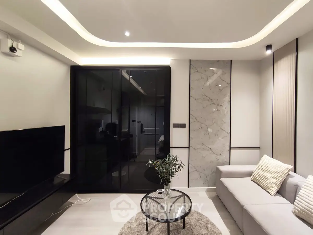 Modern living room with sleek design, marble accents, and ambient lighting