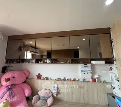 Charming bedroom with mirrored cabinets and plush toys, perfect for a cozy and inviting atmosphere.