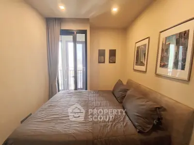 Cozy bedroom with modern decor and balcony access in a stylish apartment.