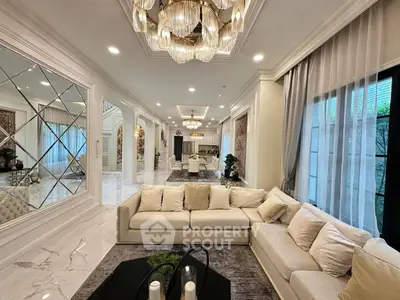 Luxurious living room with elegant chandelier and plush seating in a modern open layout