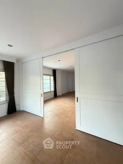 Spacious interior with sliding doors and natural light, ideal for modern living.