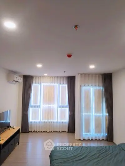 Modern bedroom with large windows and stylish curtains