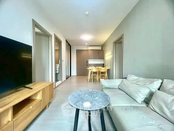 Modern living room with sleek furniture and open layout in a stylish apartment.