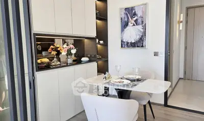 Modern dining area with elegant decor and compact kitchen in a stylish apartment.