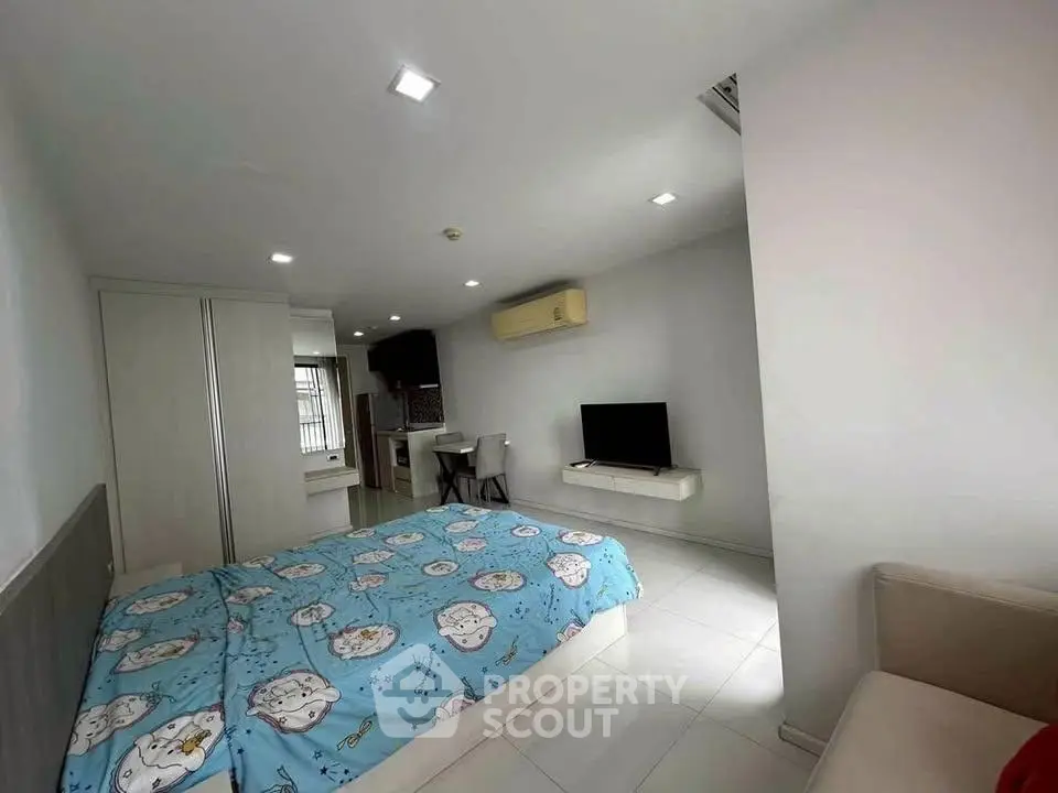 Cozy bedroom with modern decor and air conditioning in a stylish apartment.