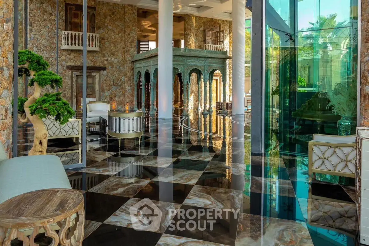 Luxurious living room with marble floors and elegant decor in a high-end property.