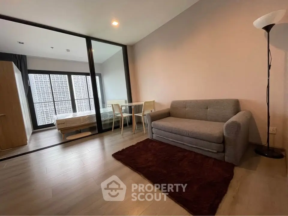 Modern studio apartment with cozy living area and bedroom partition
