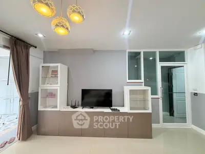 Modern living room with sleek cabinets and stylish lighting, perfect for contemporary living.