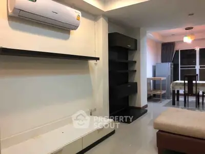 Modern living room with sleek furniture and air conditioning unit