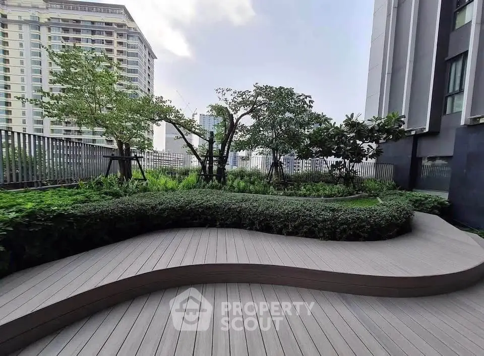 Modern urban garden with lush greenery and sleek wooden deck