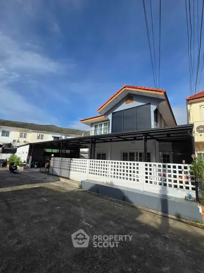 Charming two-story house with modern facade and spacious driveway in a serene neighborhood.