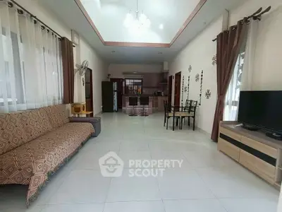 Spacious open-plan living room with modern kitchen and elegant decor