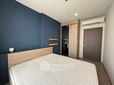 Modern bedroom with stylish blue accent wall and wooden furniture