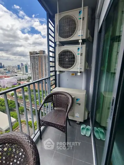 Charming balcony with city view and air conditioning units, perfect for relaxation in urban setting.
