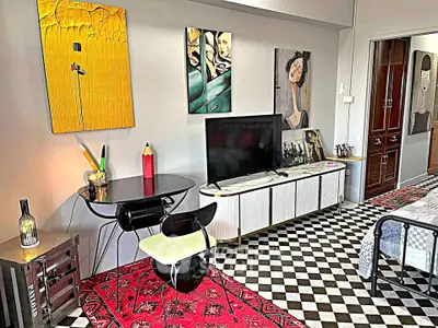 Stylish living room with modern art, checkered floor, and sleek furniture