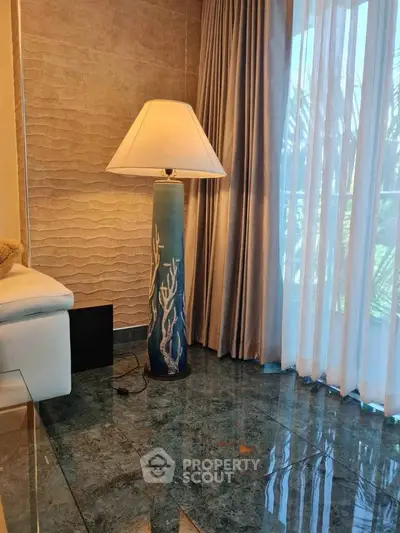 Elegant living room corner with stylish floor lamp and large window view.