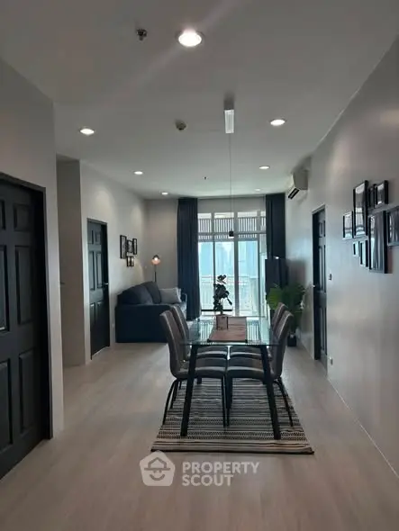 Modern dining area with sleek furniture and natural light in a stylish apartment.