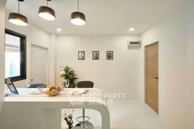 Modern kitchen with sleek design and open layout, featuring stylish lighting and minimalistic decor.