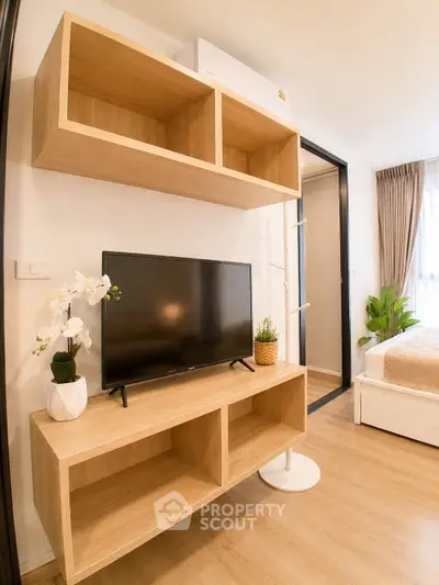Modern living room with wooden TV stand and cozy decor